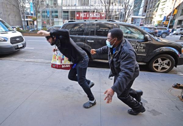 The Duane Reade at 401 Park Ave South, wher<em></em>e store security guard Augustine Nwando (black jacket, blue shirt) apprehended a shoplifter who was taken away in handcuffs by the NYPD