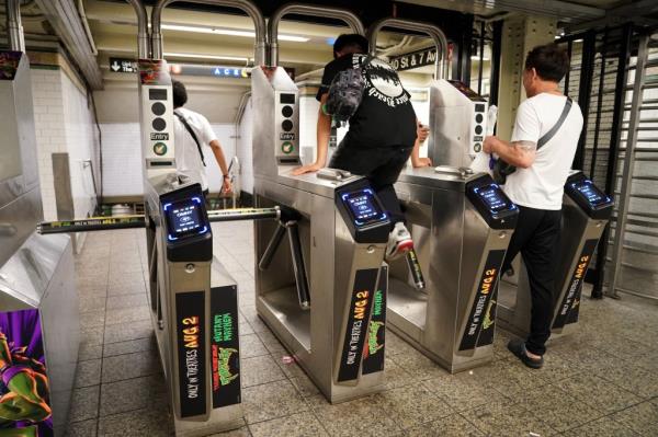 A general view of a person jumping a subway turnstile in New York, NY on July 15, 2023. 