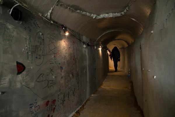 A woman walks through a featured tunnel in Tel Aviv that simulates a Hamas tunnel.