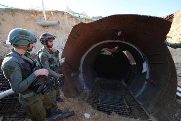 Israeli soldiers stand at the entrance to a Hamas tunnel near the Erez border.